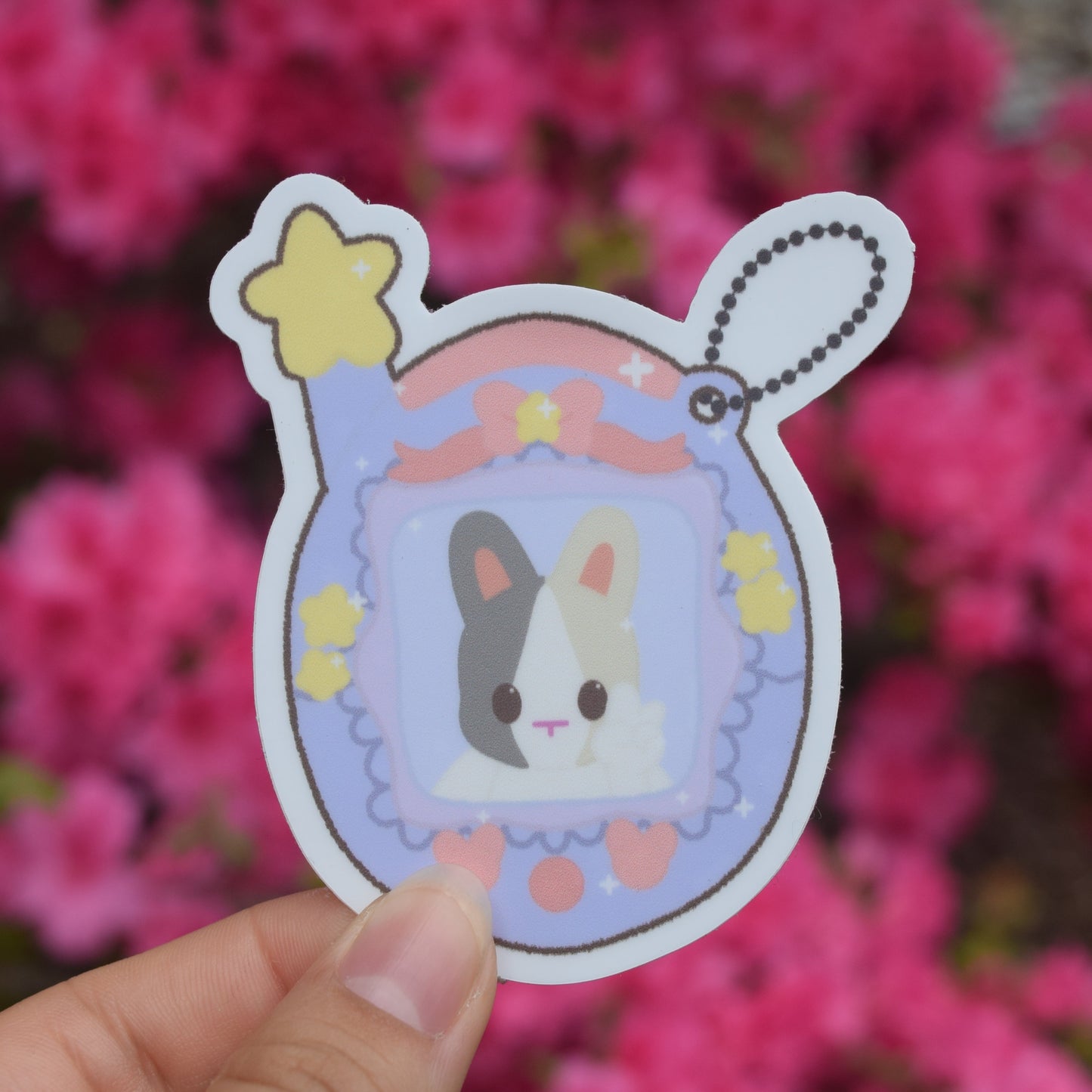 purple tamagotchi with bunny in the center. little accents of pink and yellow shapes