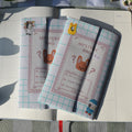  cute pastel-colored mystery bag with 1 sticker sheet, 1 die cut, and 1 journaling sticker inside the mystery bag