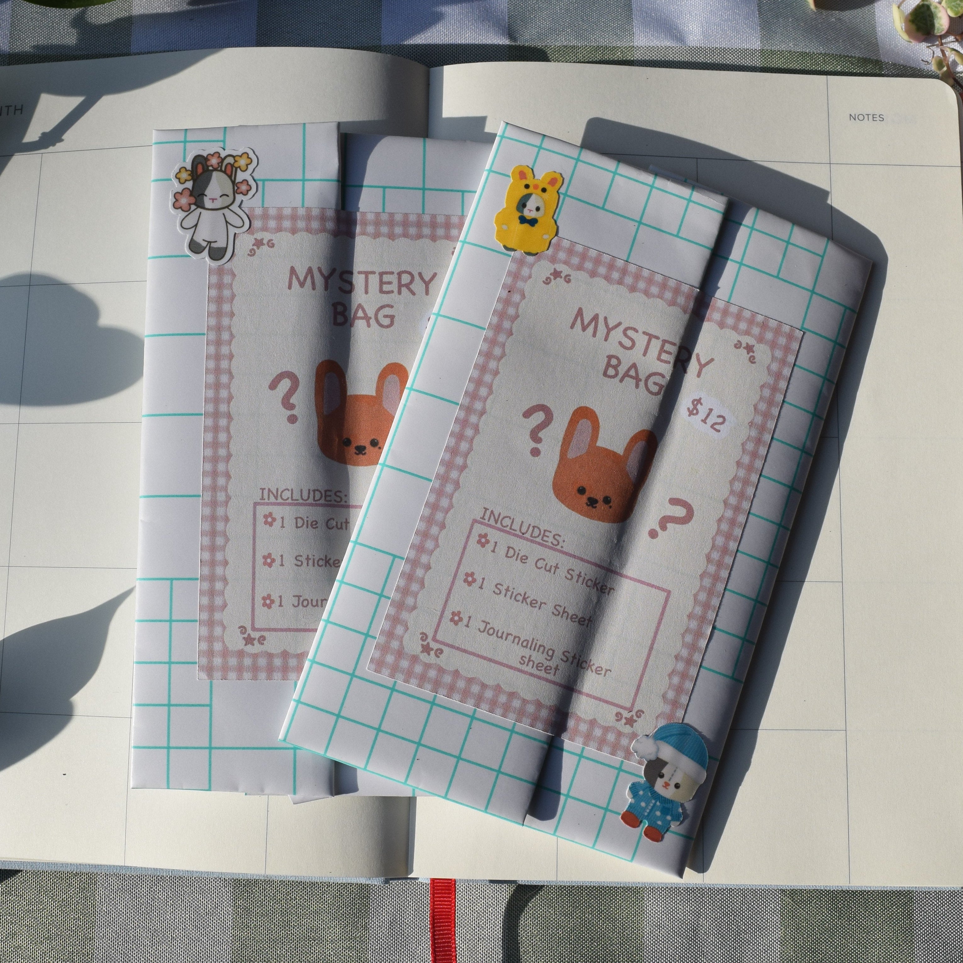  cute pastel-colored mystery bag with 1 sticker sheet, 1 die cut, and 1 journaling sticker inside the mystery bag