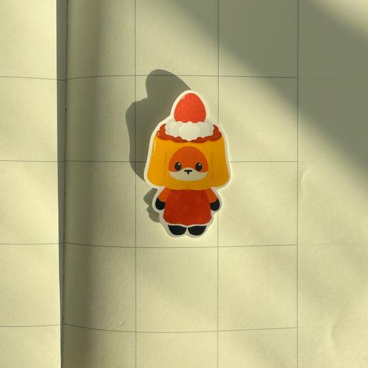 Notebook with a sticker of a cartoon character on a wooden surface