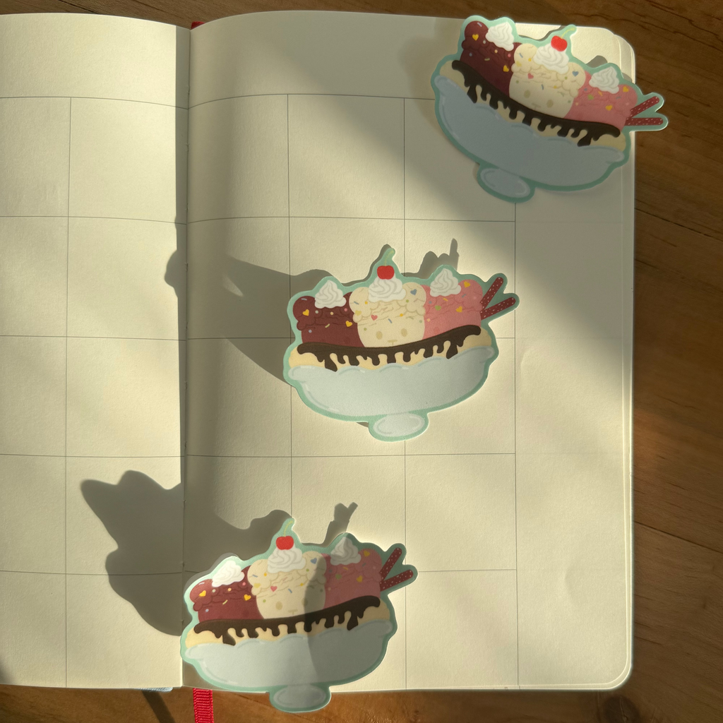Stickers of ice cream sundaes on a notebook with grid lines