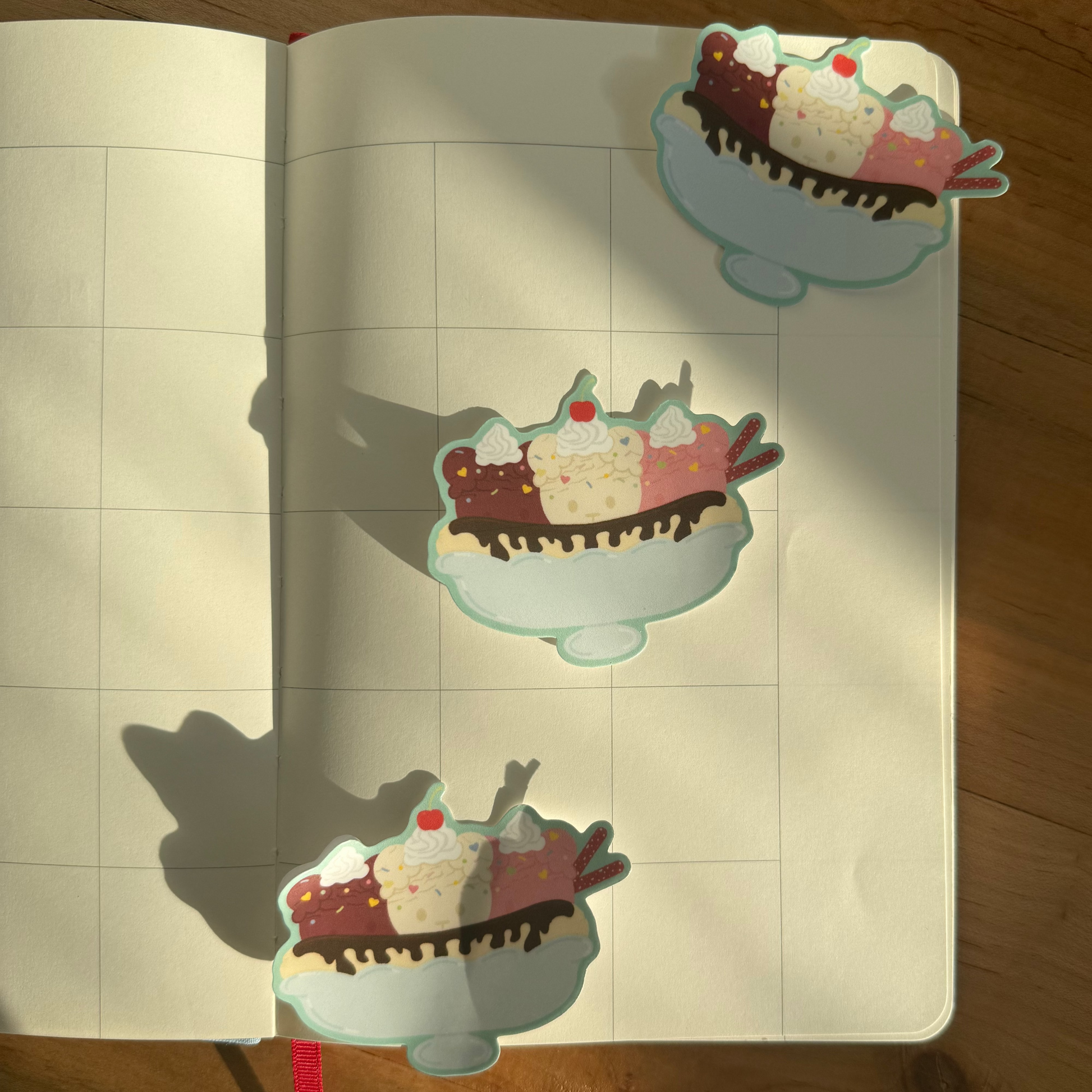 Stickers of ice cream sundaes on a notebook with grid lines