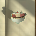 Open notebook with a sticker of a bear banana split on a wooden surface